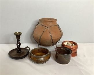 Includes (1) clay vase with stand, H 11"x W 11", (1) wooden candlestick holder, H 7"x W 6", appears to have been repaired, (1) dark colored ceramic pot, H 3"x W 5" and (2) wooden dishes, H 3.5"x W 5" and H 2.5"x W 6.5", (1) comes filled with seashells. All are used condition.