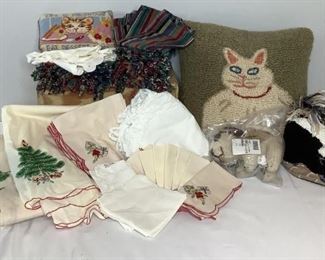 ncludes (1) Kenana Knitter Critter dog that appears to be in original packaging, (2) cat pillows H 15"x W 15" and H 7"x W 9", large pillow has a snag but otherwise in good condition. One (1) stuffed decorative skunk, (1) square Christmas tablecloth, (1) round Christmas tablecloth, small Christmas table linens,white table linens with some staining, eight (8) multicolor placemats in good condition, and eight (8) multicolor napkins in good condition.