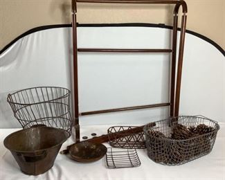 Includes (1) wooden quilt rack, H 34"x W 26"x D 12", has broken knob attachment and unable to fully assemble, (1) wire basket with pine cones, H 6"x W 19"x D 11", (3) wire baskets, largest is W 11'x D 15", smallest is H 1"x W 6.5"x D 7.5". Also (2) metal dishes, (1 )H 6"x W 16"x D 12" and (1) H 2"x W 8"x D 8". All are in used condition.