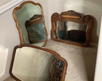 Includes (3) wall mirrors, (1) has carved accents along the top, H 22.5"x W 27.5", (1) is rectangular with rounded corners, H 30"x W 23" (has small crack at top in the bevel) and (1) scalloped edges, H 20"x W 30". All have beveled glass mirrors. All have scuffs, scratches.