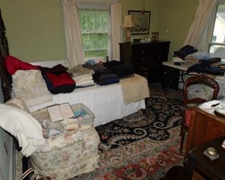 Overview of packed small back bedroom 
