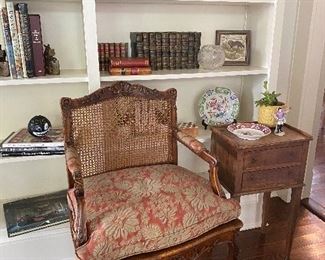 Lovely Regence arm chair in vintage Fortuny fabric, French side table, great books and pretty porcelains 