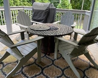 4 Resin Adirondack  Malibu Living Chairs with White Craft fire pit table with stones.