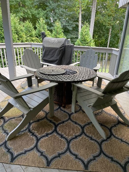 4 Resin Adirondack  Malibu Living Chairs with White Craft fire pit table with stones.