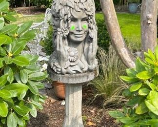 Concrete pedestal with hard plastic lady head