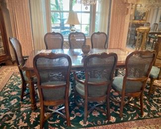 Dining set with 8 caned chairs, two leaves. and table protectors 