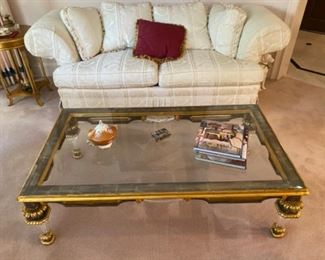 Antique glass-topped gold/green coffee table with glass legs 