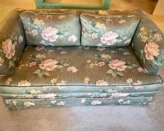 Custom upholstered loveseat with piping and skirt
