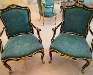 Pair of green chairs with black frame and gold trim