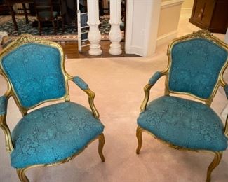 Pair of green chairs with gold frame