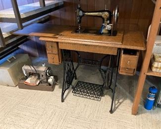 Vintage Singer sewing machine in table stand, Montgomery Wards portable sewing machine