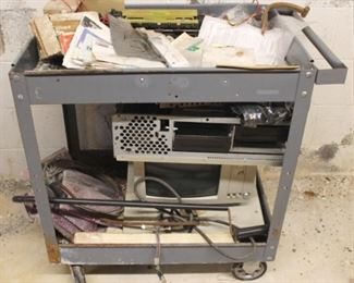 958 - Metal Rolling Cart with Contents 31" x 33" x 22" Please note that items stored in basement may be moldy