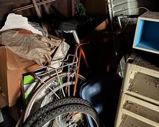 A vintage Raleigh bike hiding in the attic shadows