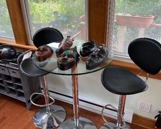 Contemporary bar stools and counter. More African masks.