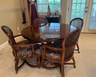 Century table and 4 chairs. Chairs roll. 
