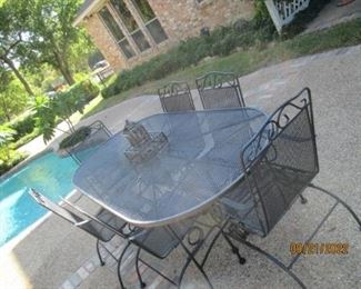 Heavy wrought iron table and 6 chairs.