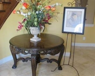 Beautiful entry table with floral, large print, picture stand.