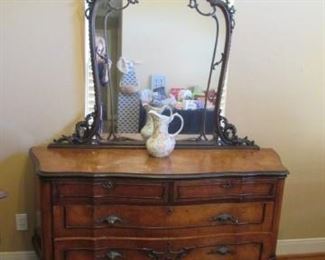 Very old dresser with ornate mirror.