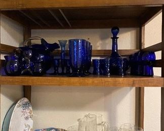 Rolling Cart Stand, Ceramic Granny Set, Cobalt Blue Glassware, Assorted Melmac Style Serving Dishes, Princess House Pitcher and Serving Glasses