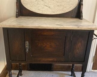 Antique washstand marble top and back with towel bar and cabinet and spindle legs. 30” W  X 17” D X 30” H at cabinet top and 43” H at back. $300
