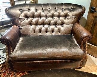 Distressed Elegant mix of silk velvet, leather and embossed leather in this tufted back loveseat
