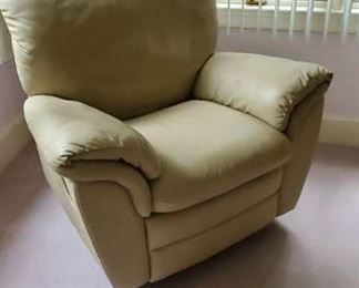 One of two leather recliner swivel chairs