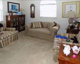 Den with Matching Armchairs and Loveseat, Bookshelf, Framed Art, Office Supplies, Small and Collectible Items.