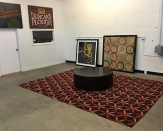 Huge rug, large round coffee table, large art