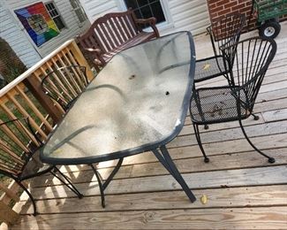 outdoor dining table with 4 heavy metal chairs, on deck
