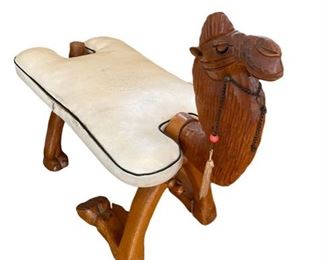 $200 - Vintage Moroccan Camel Saddle Stool Hand Carved With Original Beading ES99-16                                     This hand-carved camel stool was made in Morocco, probably in the 1960's or early 1970's. The camel has his original decorative beading, a brass-capped tail, and a very haughty expression! His off-white cushion is sculpted, piped and detachable. Perfect as a footrest, and great as a decorator piece!

Length : 26
Width : 12
Height : 23

Local Pickup McLean, VA.  Contact us for shipper suggestions.