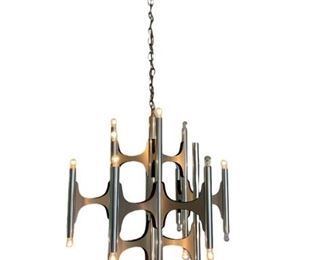 $1000 - Modernist Chandelier By Italian Designer Gaetano Sciolari ES99-31                                                                        Chrome 20 Light Candelabra Modernist Chandelier By Italian Designer Gaetano Sciolari in the 1960's. The multiple chrome arms are reinforced with a black Frame. The bulbs light each end of the shiny chrome cylinder holders. Original chrome canopy and chain Included. Angelo Gaetano Sciolari (1927-1994) was the owner of Sciolari Lighting and designer for the Italian manufacturer Stilnovo in the 1950s. It was while working for Stilnovo that Sciolari "created his most recognizable and celebrated designs, a series of multi-light chandeliers fashioned with both glossy and matte metal, conjuring up futuristic visions of the dawning space age." Throughout the 1960s, 70s, and 80s his designs were in demand, with his designs imported to the American market by Lightolier & Progress Lighting. During this same period, his designs appeared prominently in pop