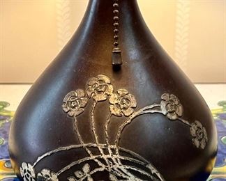 Cutout work of dianthus flowers is mirrored in sterling overlay on gourd shaped base