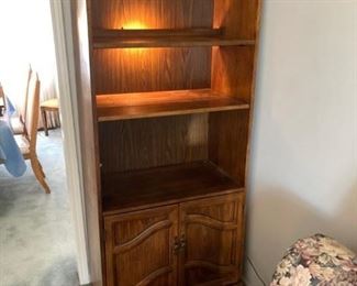 Doored, lighted bookshelf unit in walnut. Matches the other unit. 