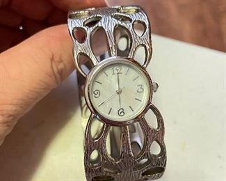 Silver articulated watch, $10