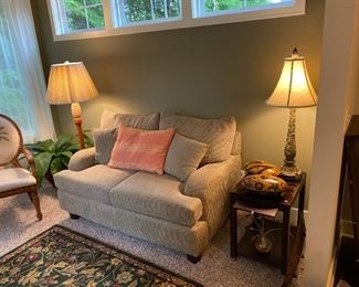 Upholstered Mactavish Furniture Co. love seat, floor lamp and table lamp