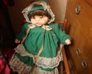 Ceramic doll in child rocker