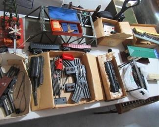 VINTAGE LIONEL TRAIN SET WITH SOLID METAL ENGINE, CRANE CAR, OTHER BOX CARS, CABOOSE WITH CONTROLLER AND TRACKS. OTHER ACCESSORIES ALSO INCLUDED IN SET. VERY COLLECTIBLE!