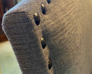 Detail of studded fabric dining chairs