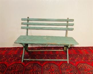 Green slatted garden bench