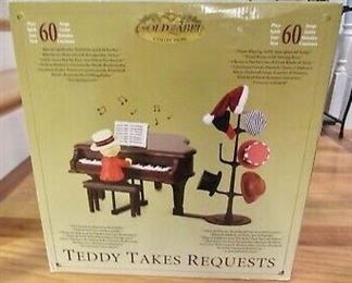 Teddy Takes Requests Musical - Put one of the six hats on his head and he will play tunes of the genre.