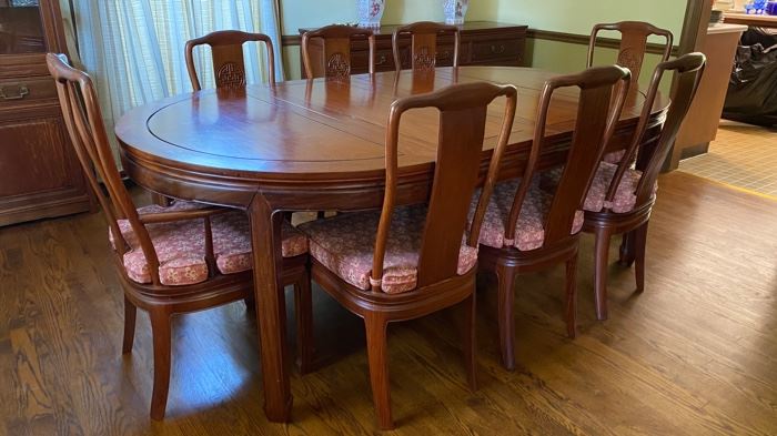 c1960 Hand carved dining table & 8  chairs. Round to large oval with leaves & pads. George Zee & Co.