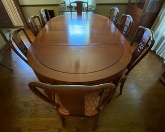 c1960 Hand carved dining table & 8  chairs. Round to large oval with leaves & pads. George Zee & Co.