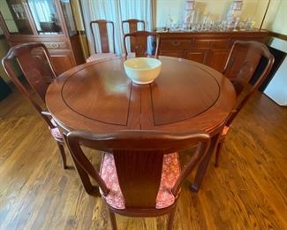 c1960 Hand carved dining table & 8  chairs. Round to large oval with leaves & pads. George Zee & Co.