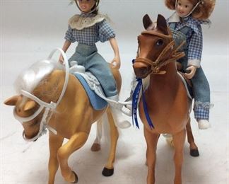 2 LITTLE DEBBIE DOLLS ON HORSES