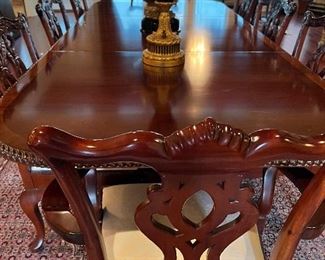 BANDED CARVED MAHOGANY DINING TABLE WITH 12 CHIPPENDALE STYLE CHAIRS  (TABLE HAS 2 ADDITIONAL LEAVES)