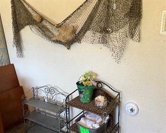Metal shelves and fish net with shells