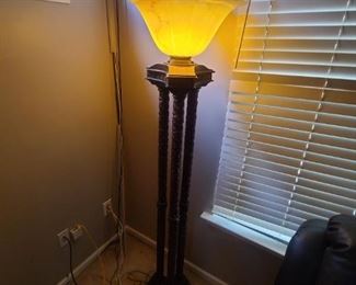 torchere style floor lamp 60" tall , alabaster type glass with 3 metal decorated poles lead down to heavy triangle base with foot button to turn on