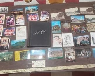 Postcard album is dated 1876 on the back.  Comes with all the postcards in the photo.  Some are very old and some are not.  Some are used with stamps and inscriptions and some are not.  