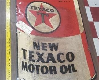 Tin litho tacker sign advertising New Texaco Motor Oil.  It has some extra nail or bullet holes.  