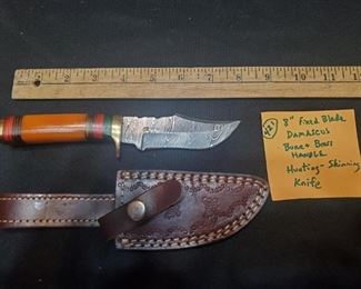 We have numerous fixed blade knives in this auction.  This one is damascus steel with tooled leather sheath and looks to be a bone handle.  
